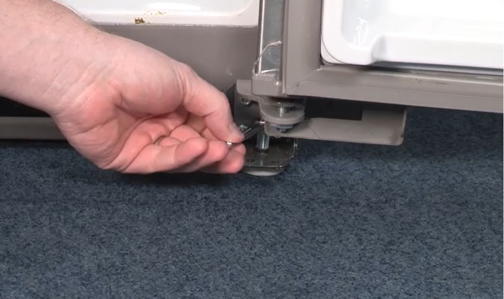 Adjusting the wheels using wrench to level your whirlpool refrigerator